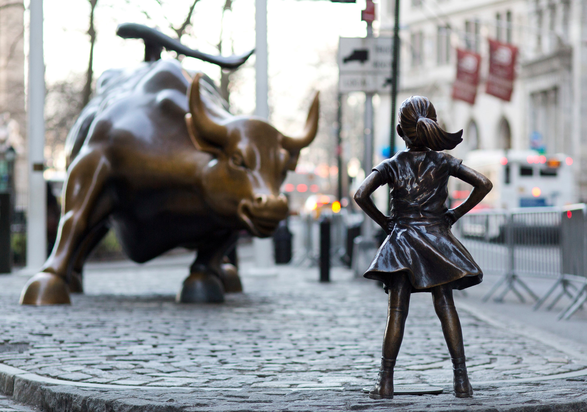 Bronze Fearless Girl statue standing defiantly on a city street, the centrepiece of State Street Global Advisors' award-winning PR campaign