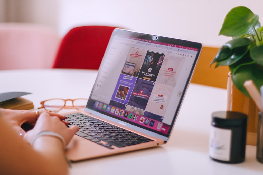 B2B marketer managing online community engagement and member interactions on laptop