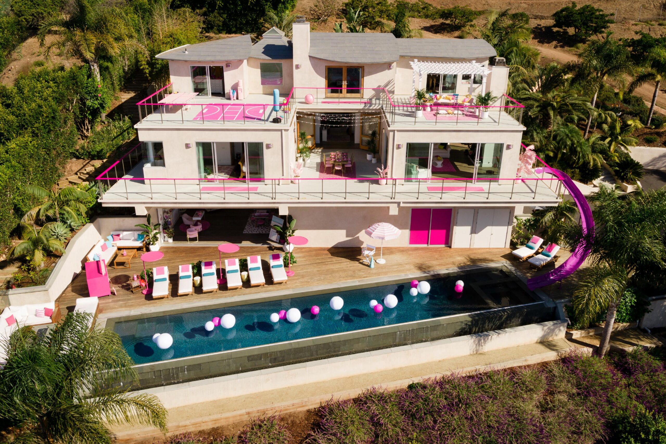 Barbie's life-sized pink Malibu DreamHouse listed on Airbnb, with an oceanfront deck and a disco dance floor