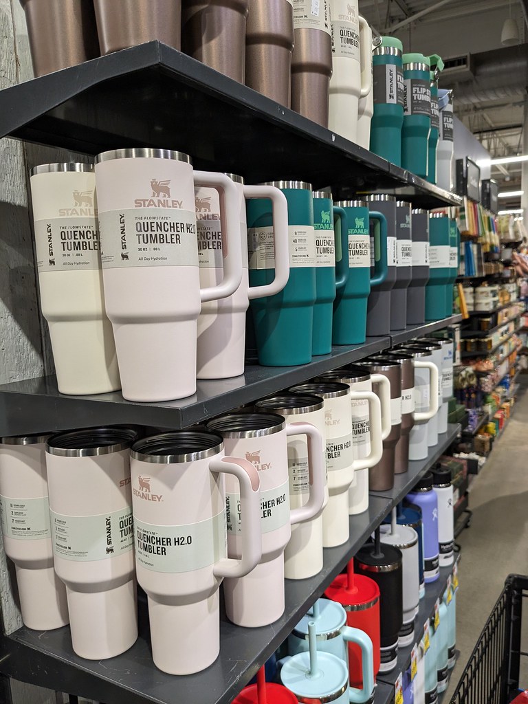 A retail shelf stacked with Stanley Quencher H2.0 tumblers in multiple colors, the viral product behind the car-fire moment