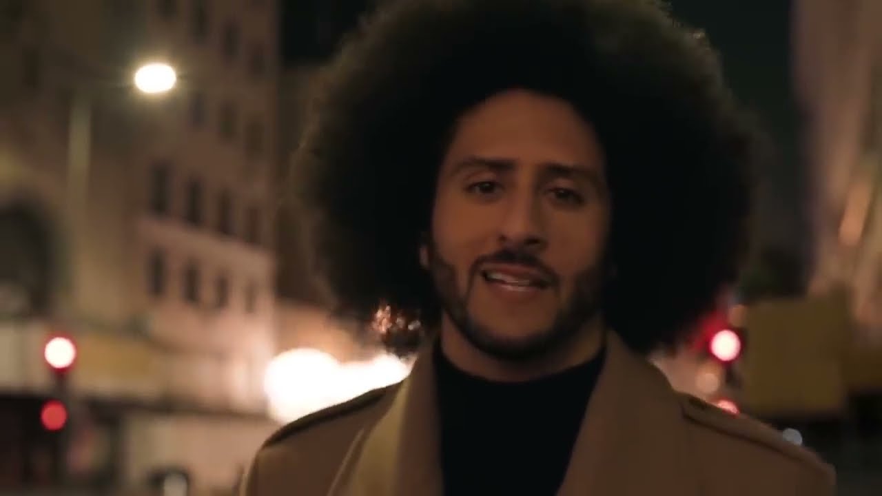 Colin Kaepernick walking a city street at night in a close-up from Nike's Dream Crazy campaign film
